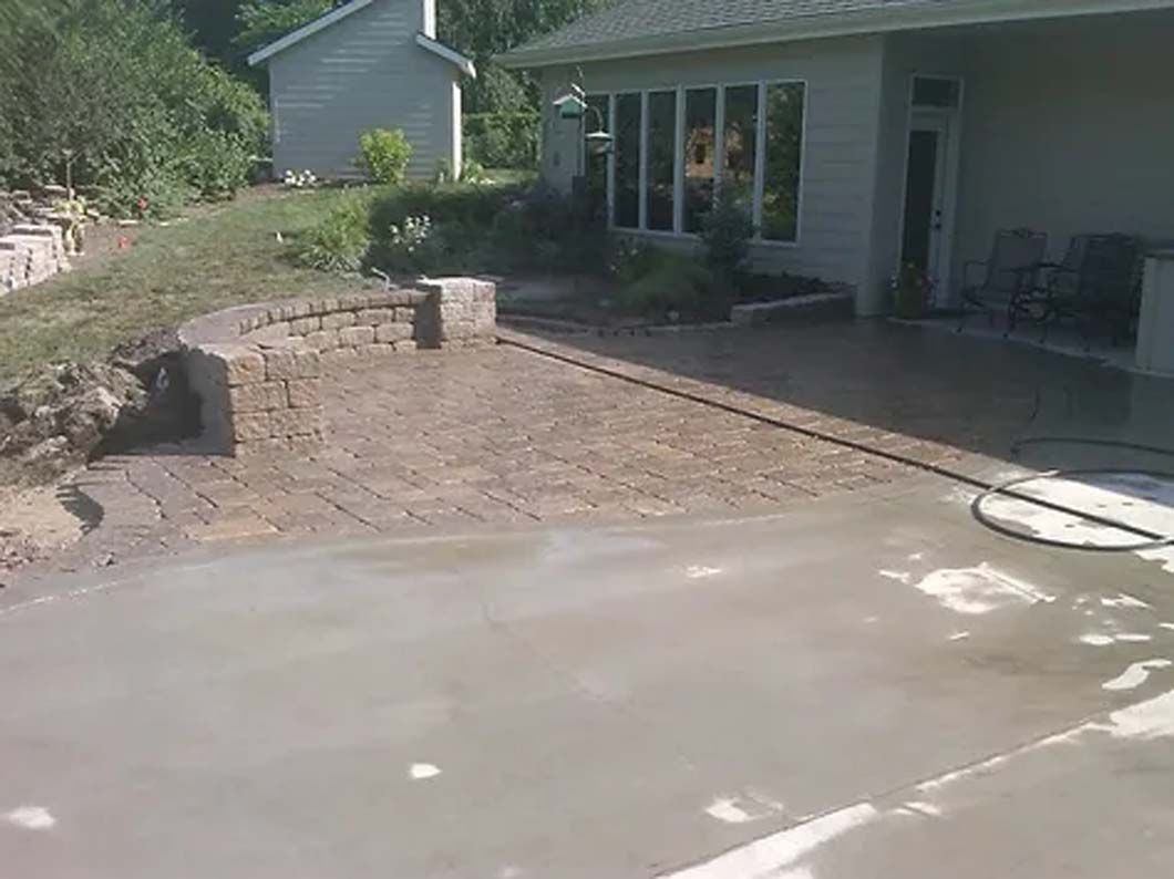 A concrete driveway is being built in front of a house.