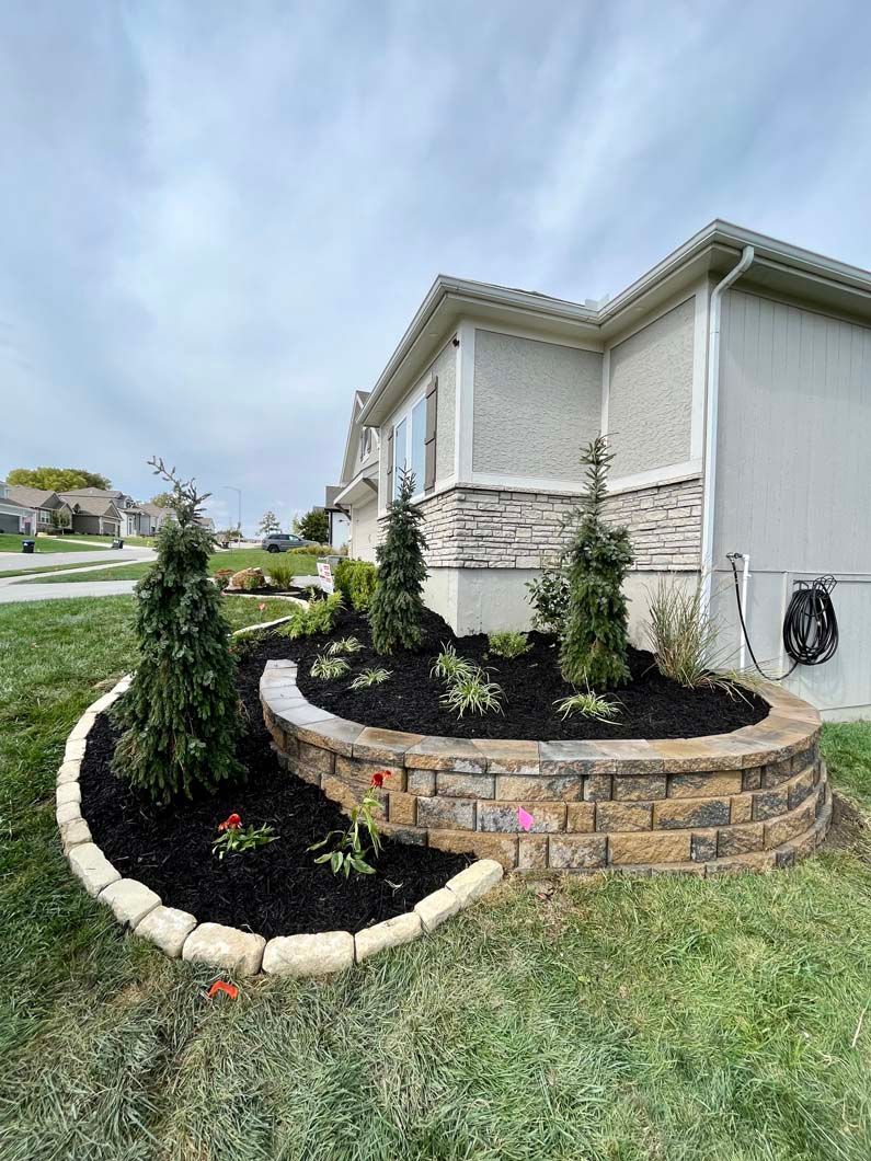 A house with a circular garden in front of it.