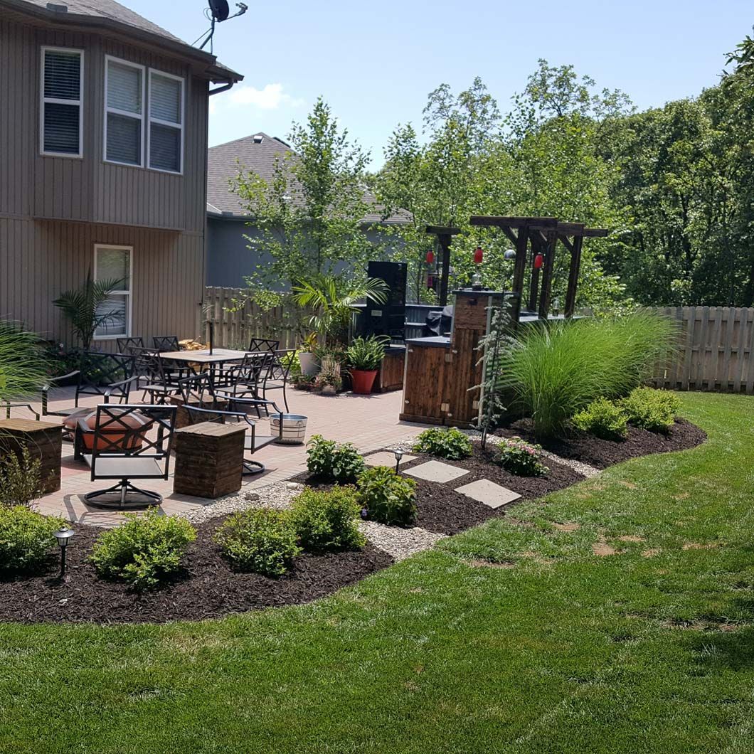 There is a fire pit in the backyard of a house.