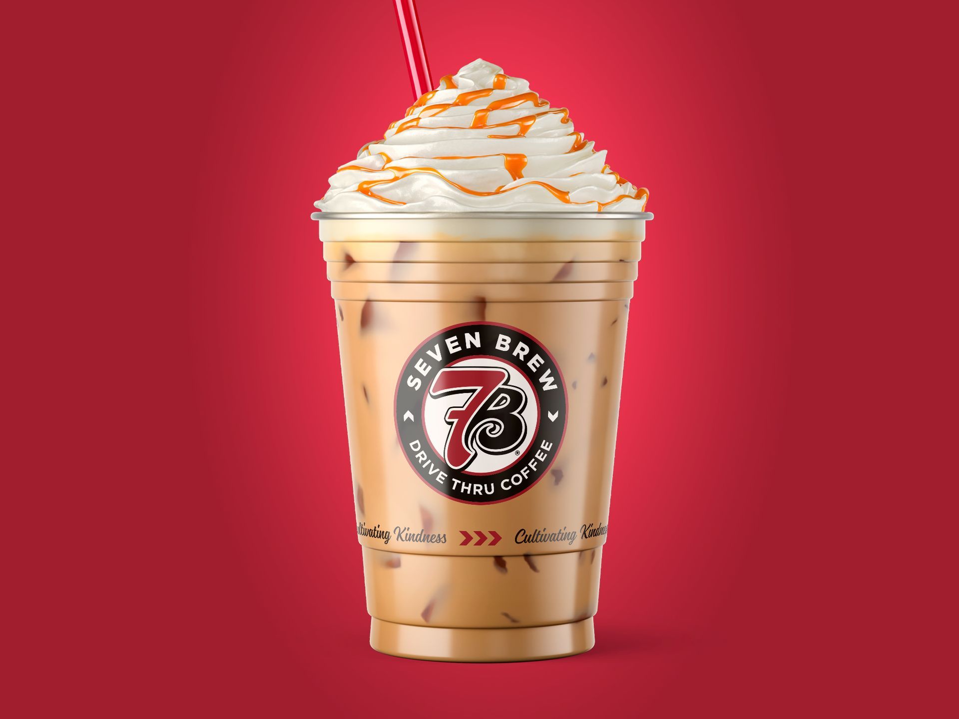 7 Brew iced coffee topped with whipped cream and caramel drizzle on a red background
