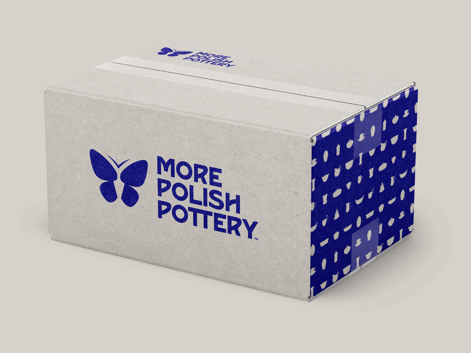 Blue and white More Polish Pottery branded packaging with butterfly logo on a plain background