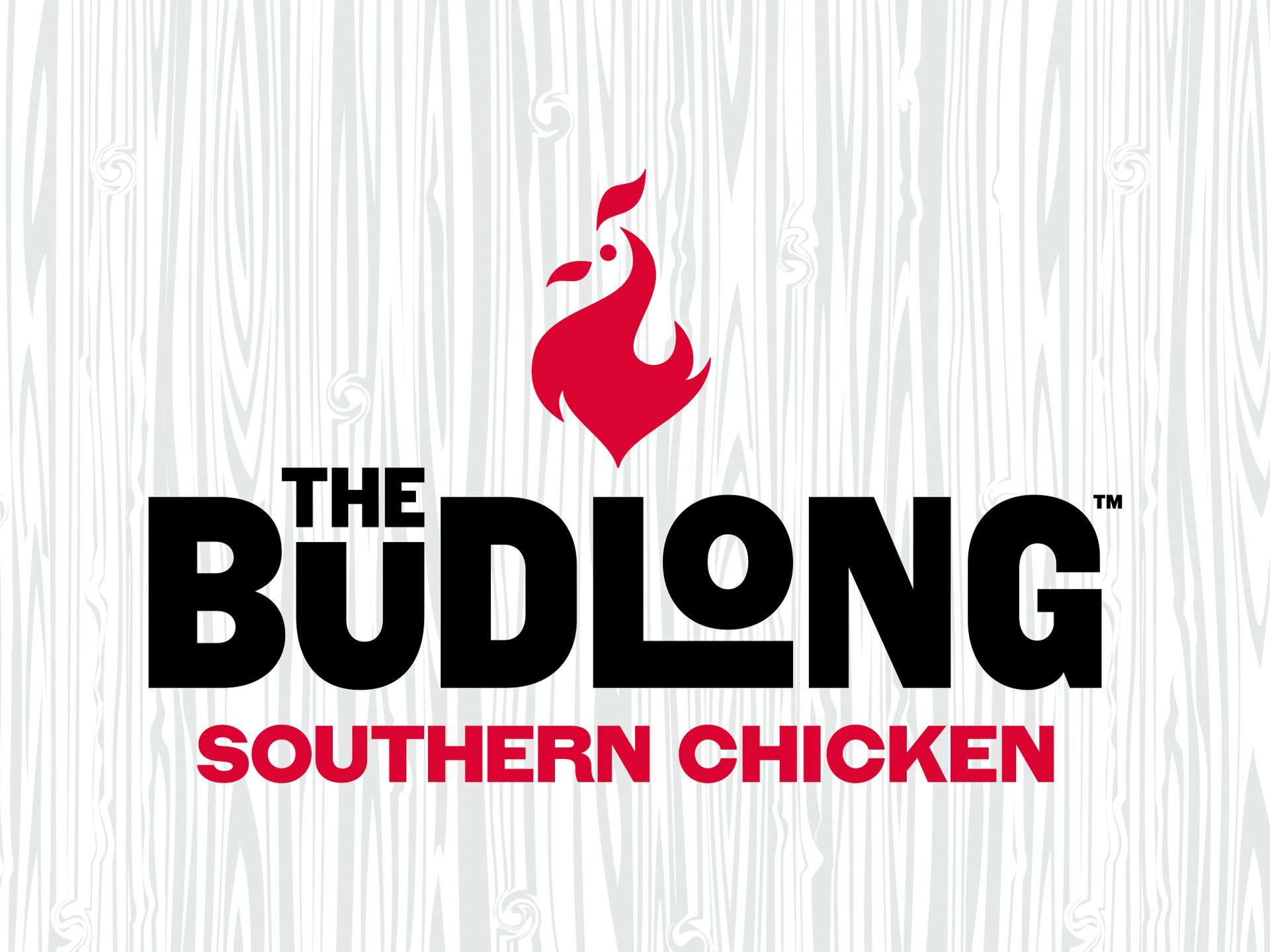 The Budlong Southern Chicken logo with black text and a red rooster on a light wood background