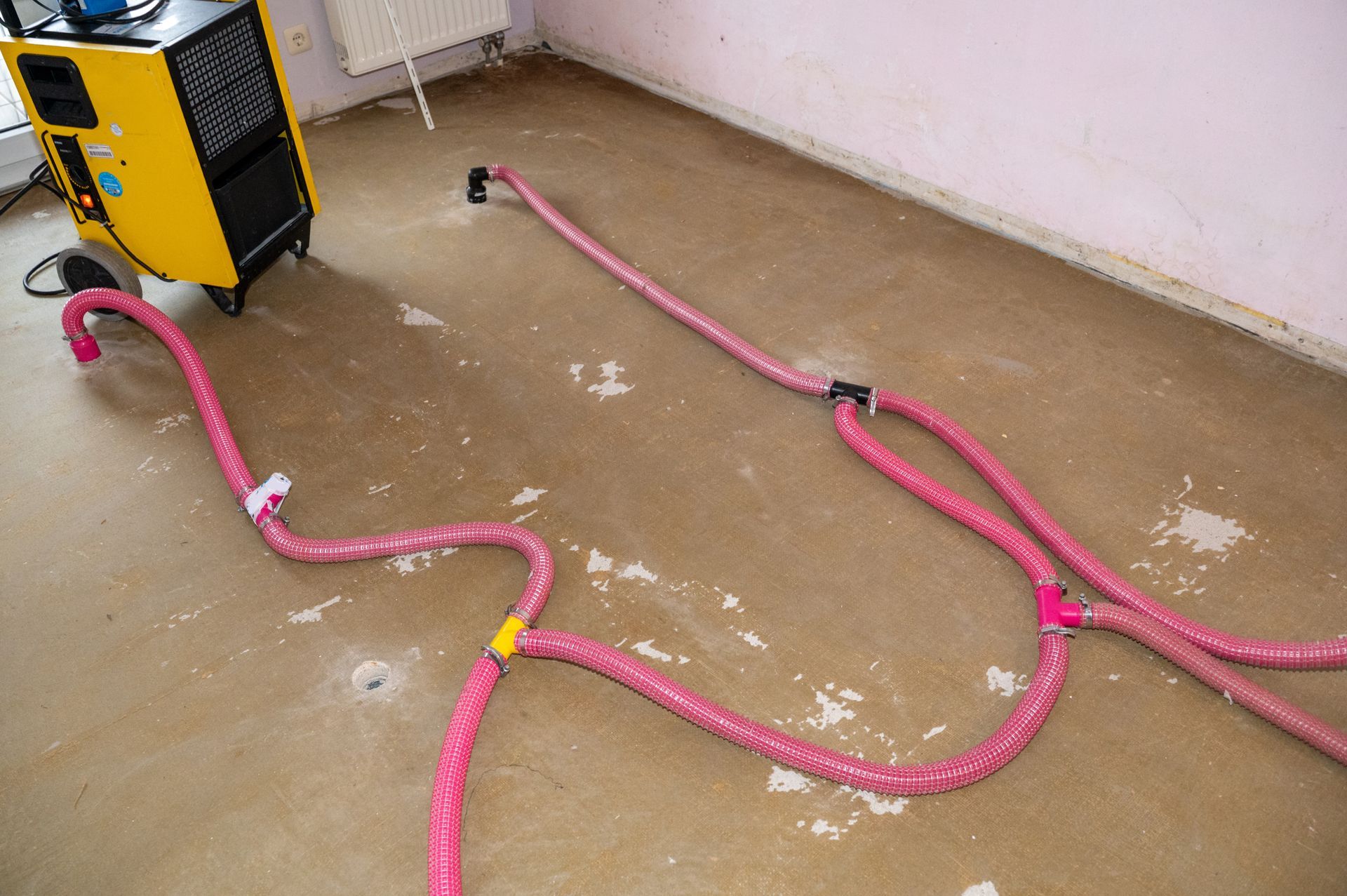 Floor drying after a burst water pipe using a dehumidifier.