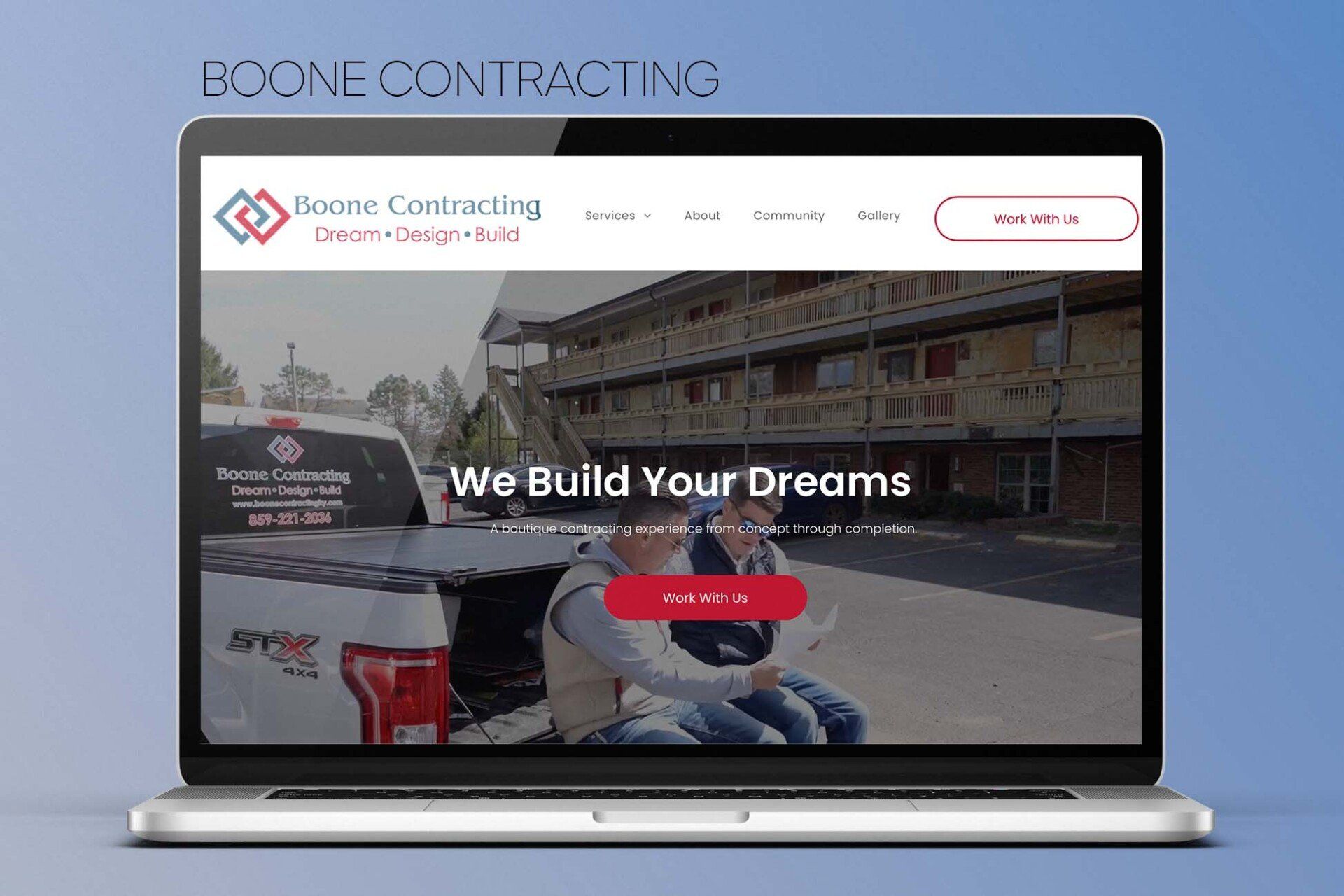 A laptop computer is open to a website that says `` we build your dreams ''.