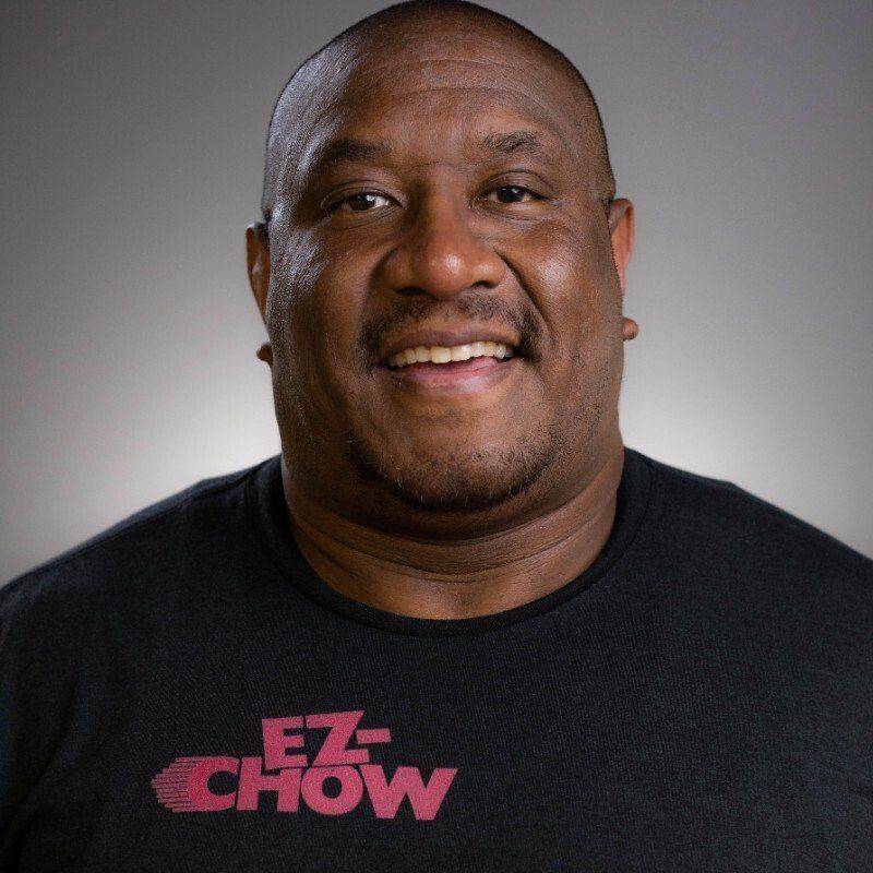 A man wearing a black shirt that says ez chow