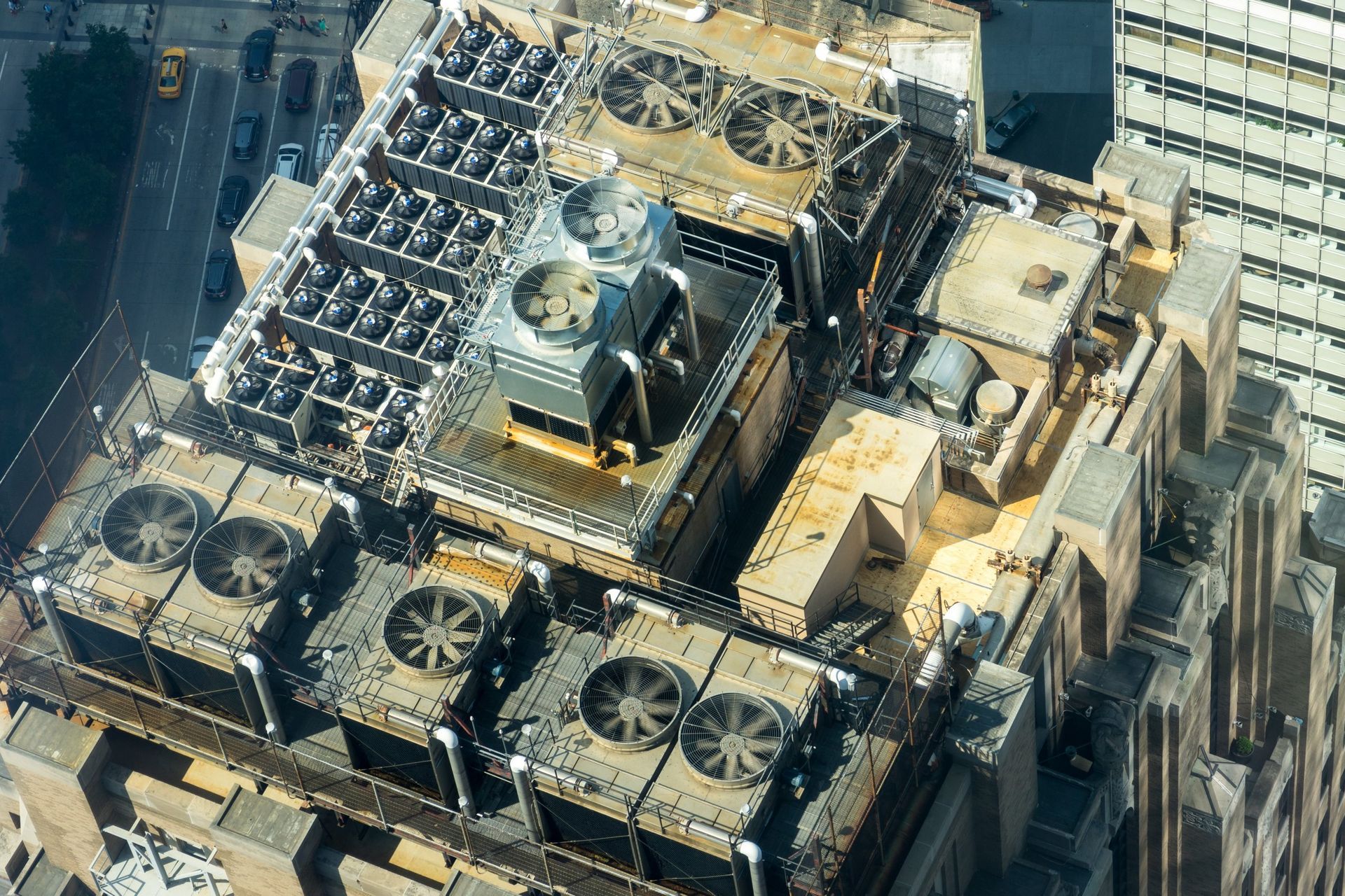 An aerial view of a building with a lot of fans on the roof