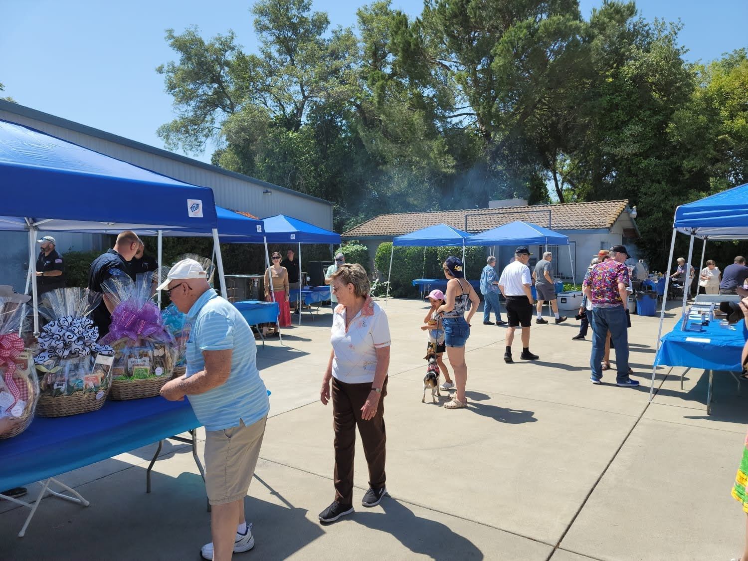 A group of people are standing around a table at a market.