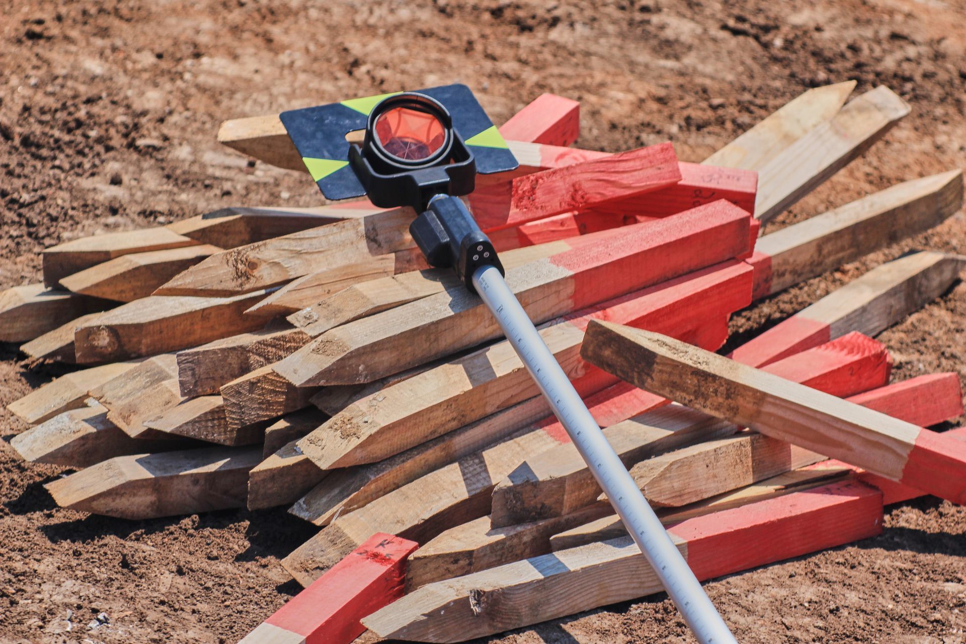A pile of wooden stakes with a compass on top of them.