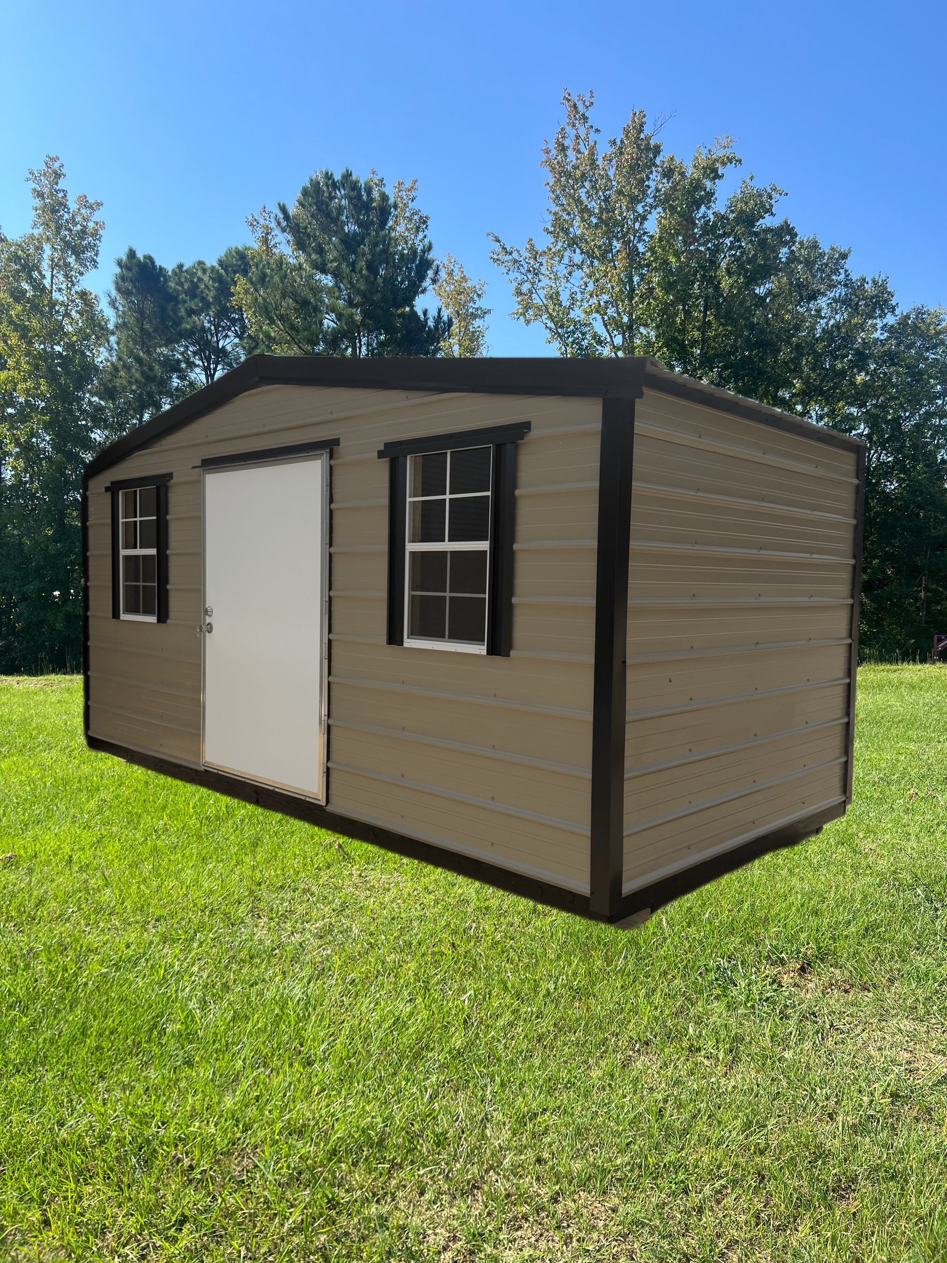 Tan portable shed with beige siding, dark trim, and white door in a sunny grassy yard.
