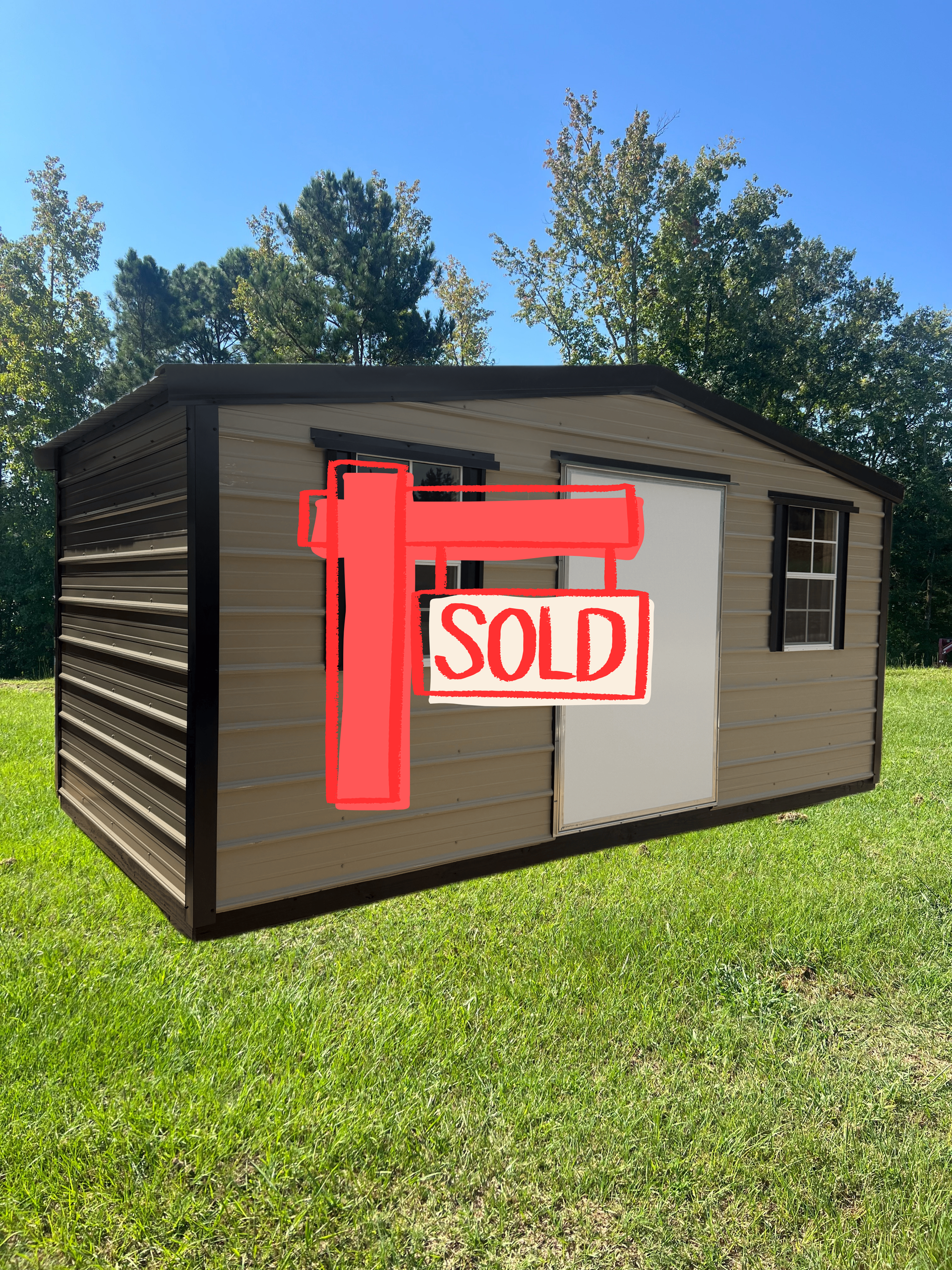 Small tan shed with white door and windows on a grassy lawn under a blue sky