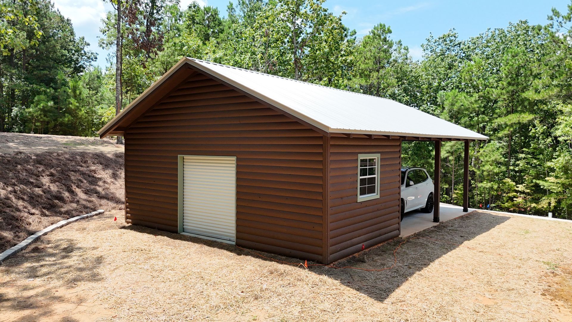 Brown cabin with metal roof and porch in a wooded clearing