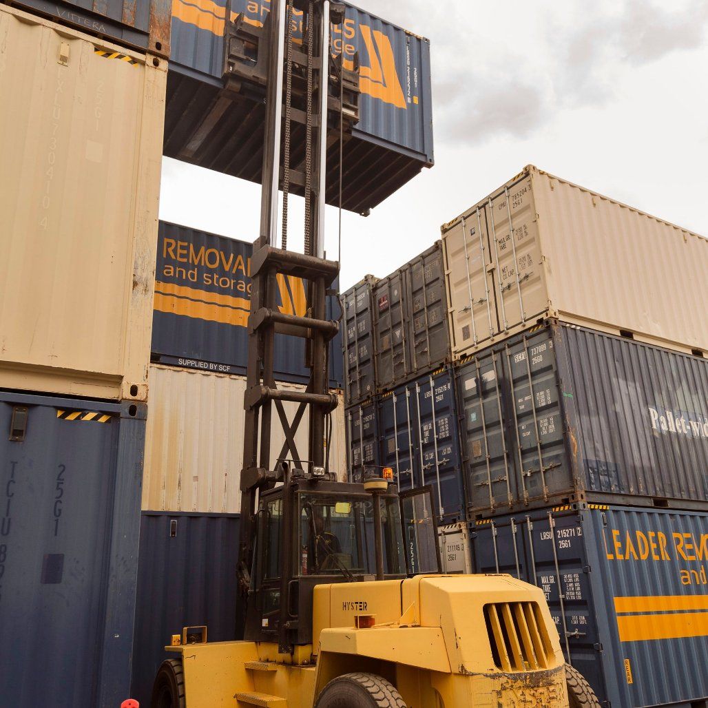 A Forklift Is Lifting a Container that Says Removal and Storage — Leader Removals & Storage in Mitchell, ACT