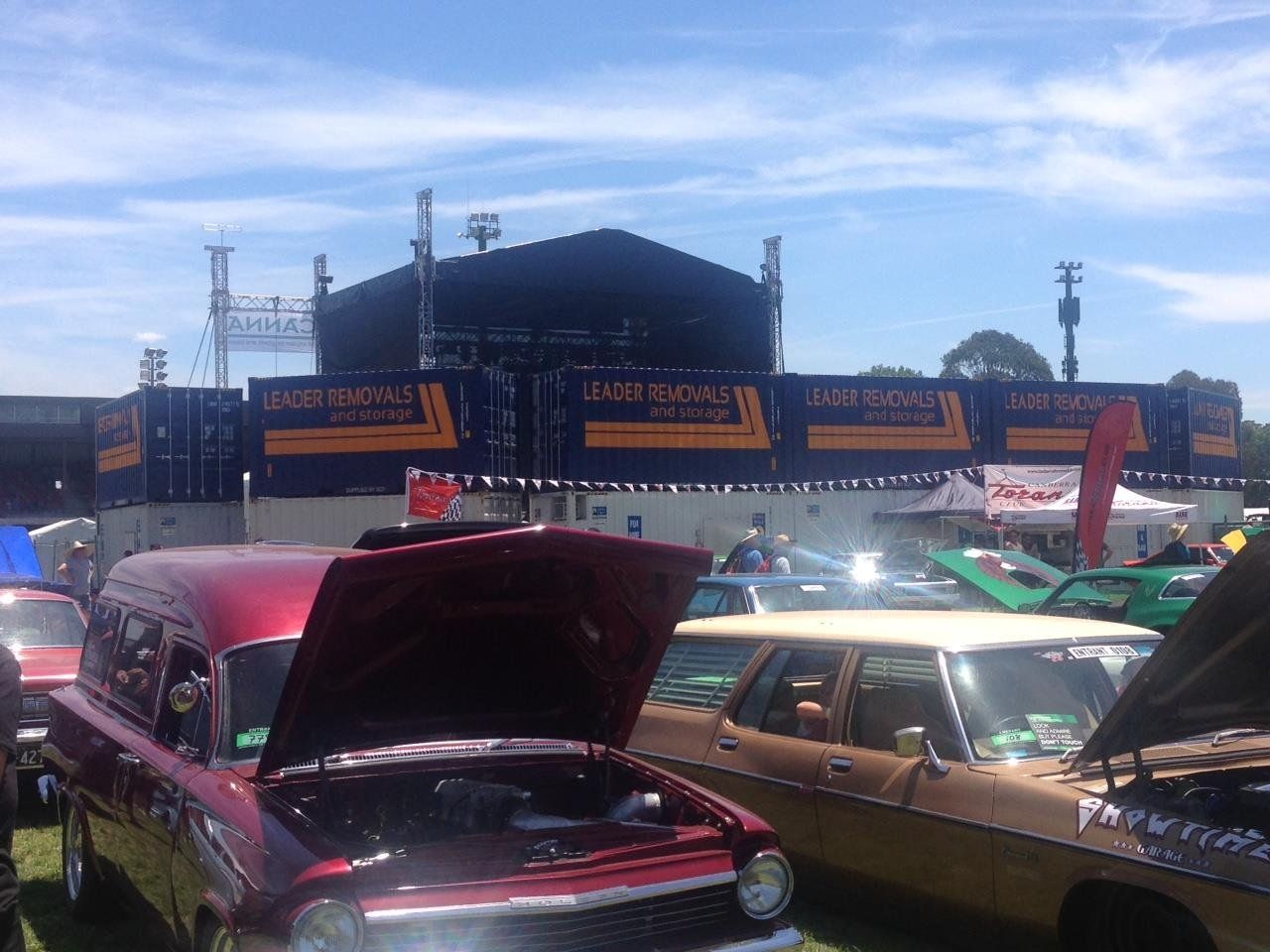 A Red Car with The Hood up Is Parked Next to A Brown Car with The Hood Up — Leader Removals & Storage in Goulburn, NSW