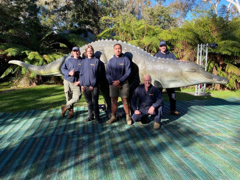A Group of People Are Posing for A Picture in Front of A Statue of A Crocodile — Leader Removals & Storage in Newcastle, NSW