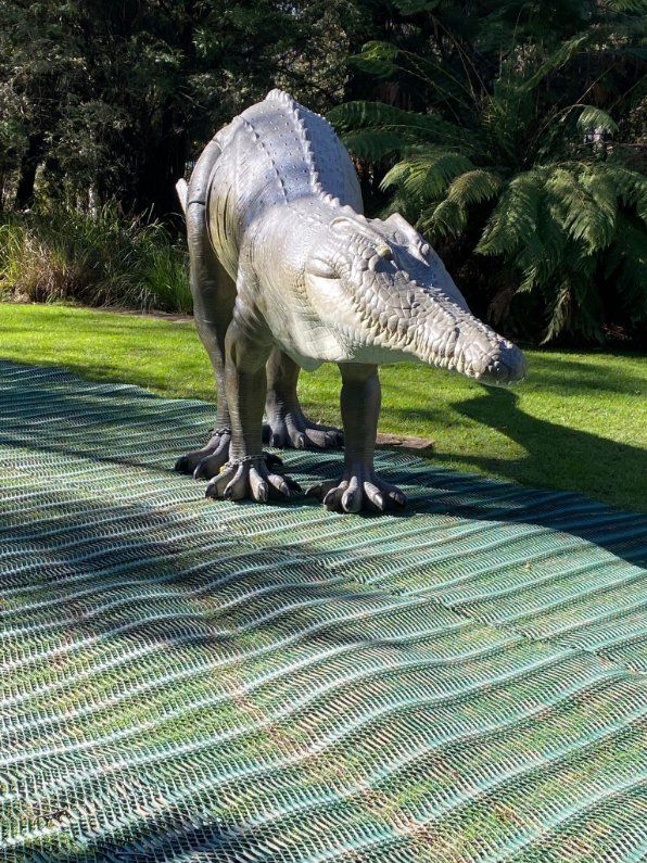 A Statue of A Dinosaur Standing on Top of A Green Mat — Leader Removals & Storage in Gold Coast, QLD
