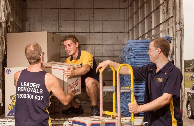 A Group of Men Are Loading Boxes Into a Moving Truck — Leader Removals & Storage in Braidwood, NSW
