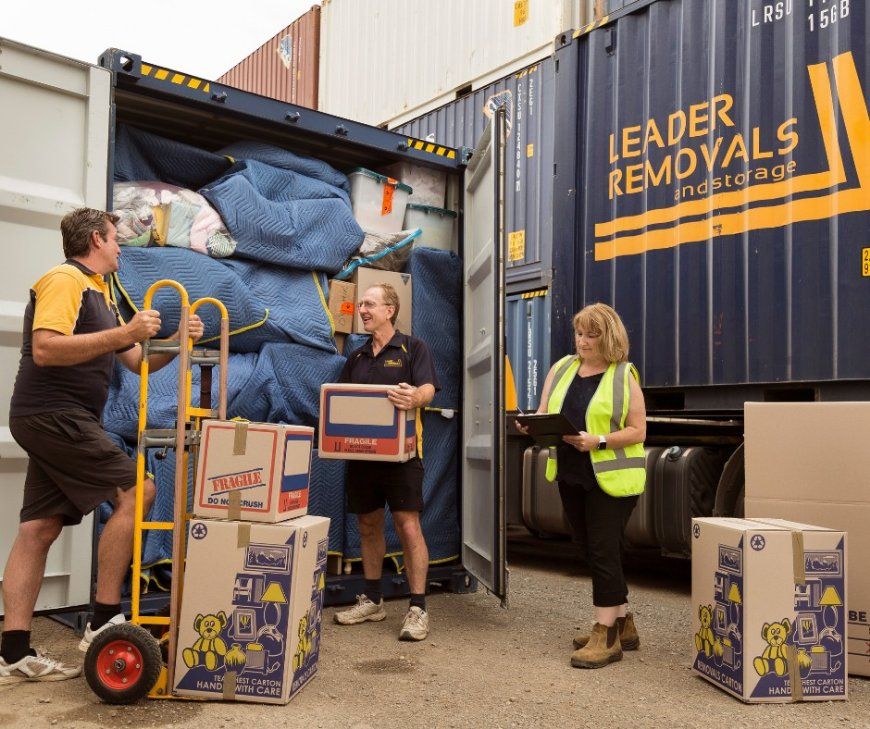 A Group of People Are Loading Boxes Into a Leader Removals Truck — Leader Removals & Storage in Gunning, NSW