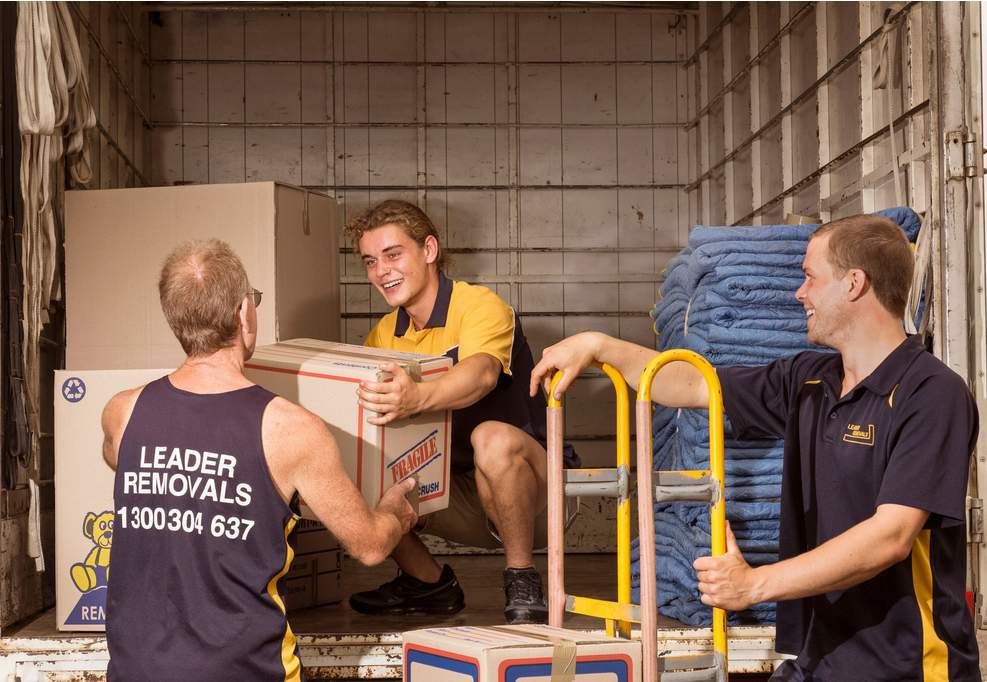 Three Men Are Loading Boxes Into a Moving Truck — Leader Removals & Storage in Mitchell, ACT