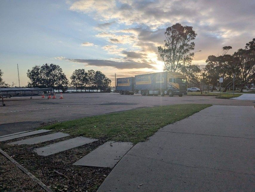 A Truck is Parked in a Parking Lot at Sunset — Leader Removals & Storage in Canberra, ACT