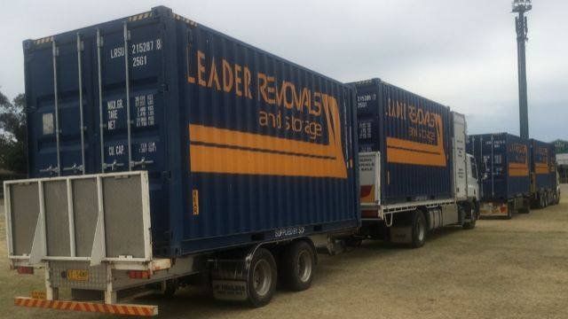 A Row of Leaders Removals Trucks Parked Next to Each Other — Leader Removals & Storage in Canberra, ACT