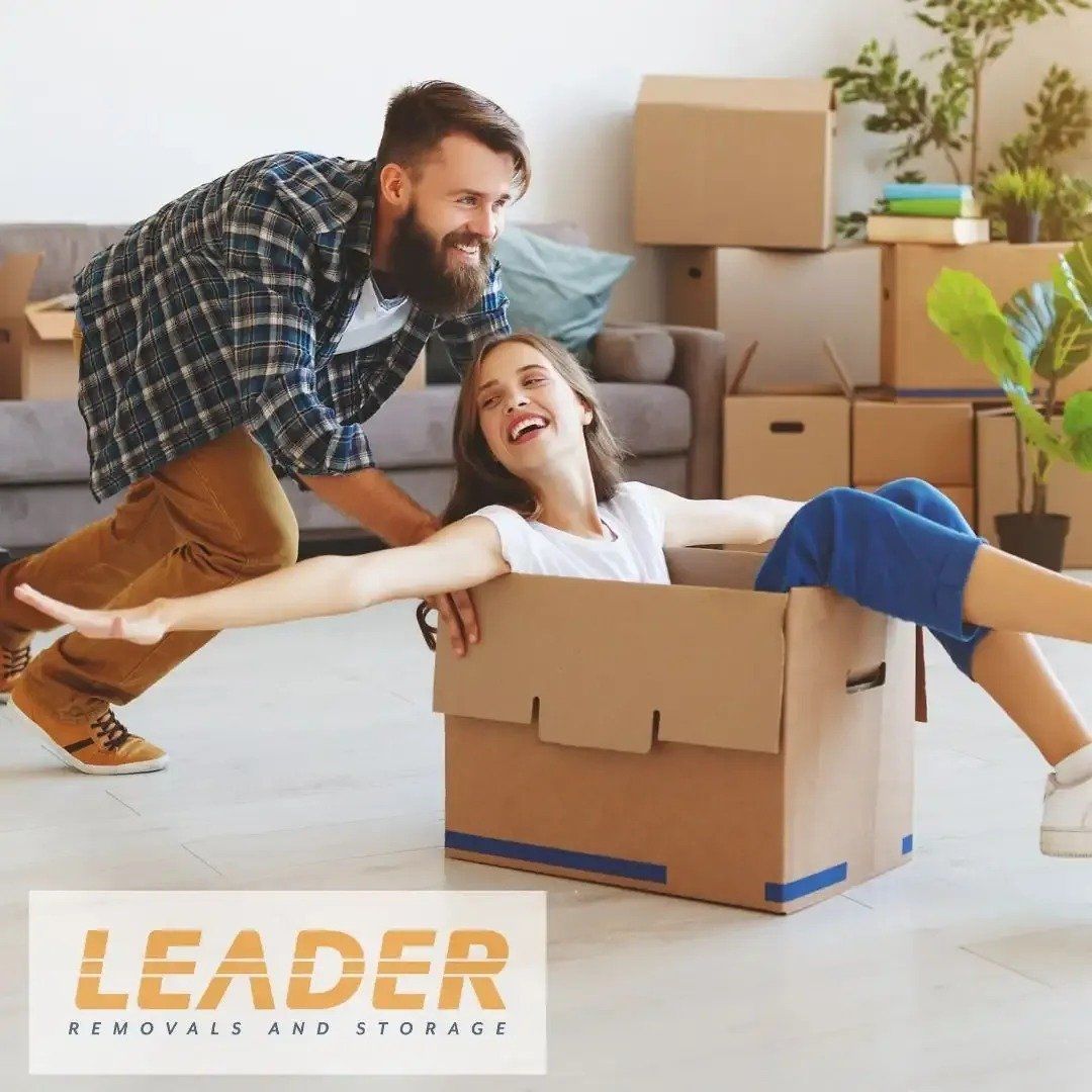 Man Pushing Woman in A Box — Leader Removals & Storage in Newcastle, NSW