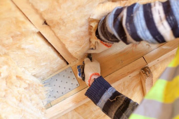 A person is working on a wooden wall.