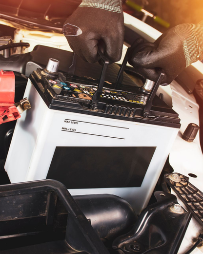 Gloved hands wiring a black control panel onto a white electronic device in a workshop. | Good Deals on Wheels Shop
