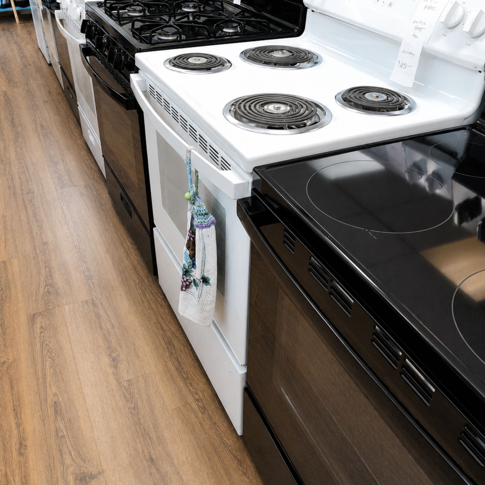 Assorted kitchen appliances on a countertop, including blender, toaster, microwave, coffee maker, and electric kettle.