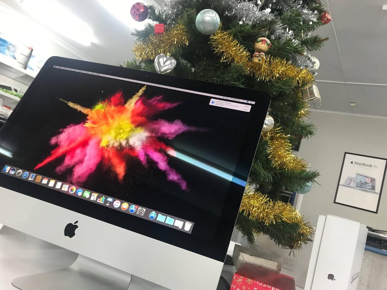 An Apple Computer is Sitting in Front of a Christmas Tree — Coastal Computing Solutions in Harrington, NSW