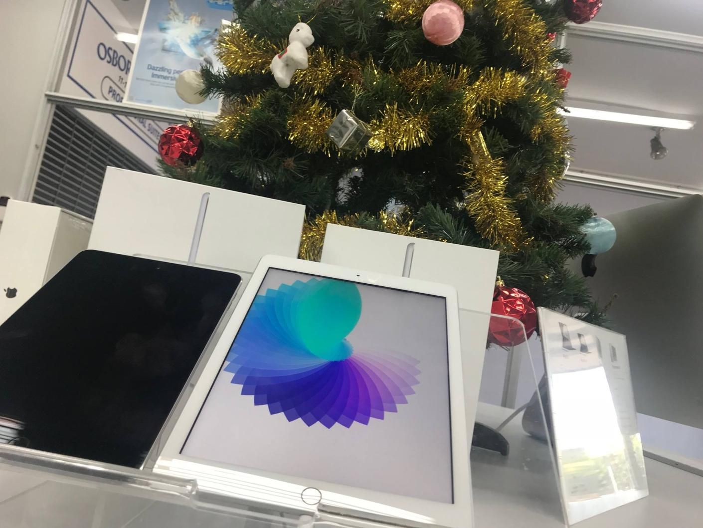 Two Ipads Are Sitting in Front of a Christmas Tree — Coastal Computing Solutions in Harrington, NSW
