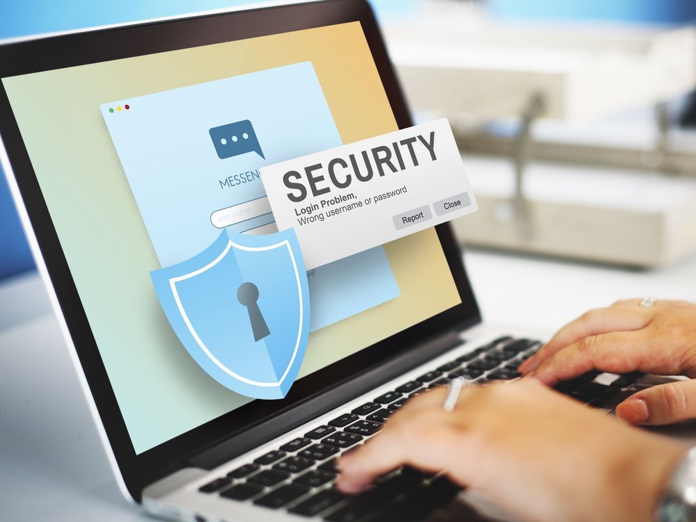 A Person is Typing on a Laptop With a Security Card on the Screen — Coastal Computing Solutions in Taree, NSW