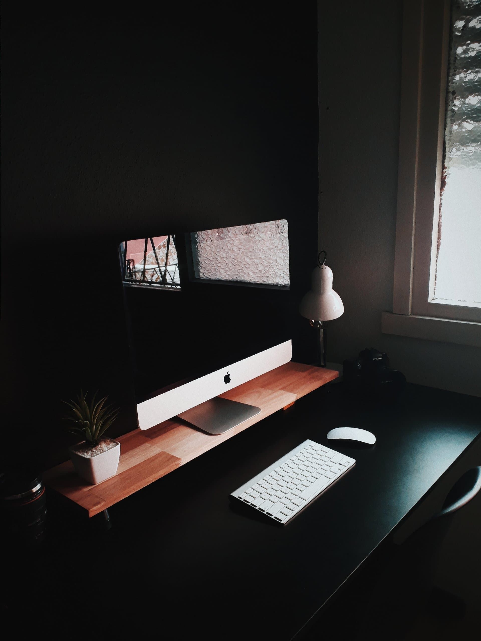 A Computer is Sitting on Top of a Desk in a Dark Room — Coastal Computing Solutions in Taree, NSW