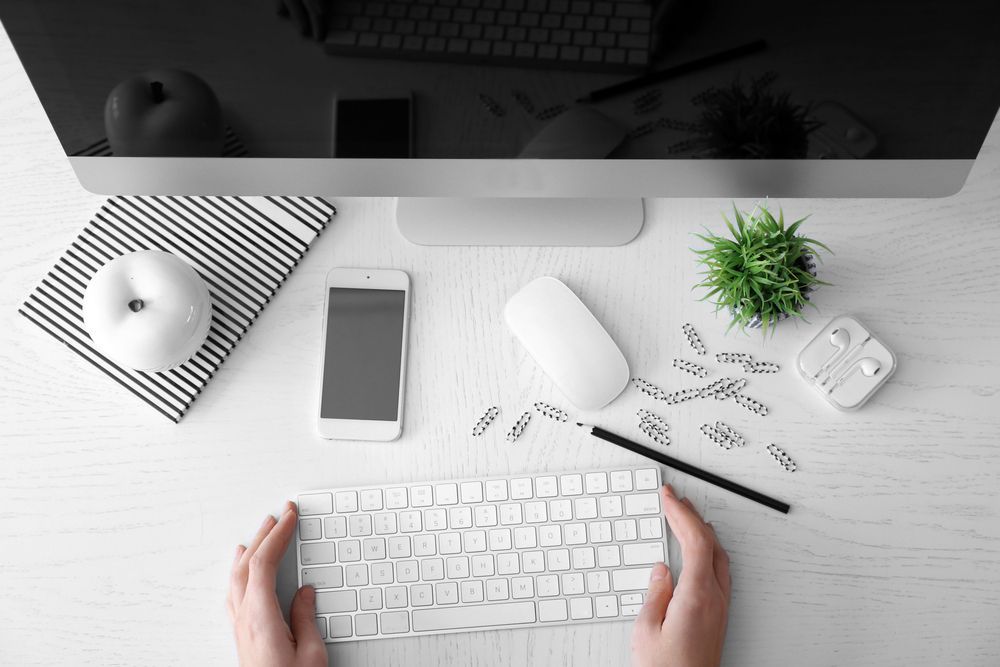 A Person is Typing on a Keyboard in Front of a Computer — Coastal Computing Solutions in Taree, NSW