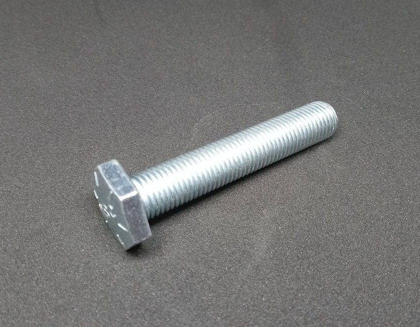 Silver hex-head bolt on a gray surface
