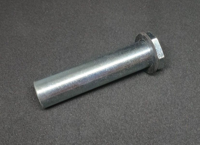 Metal bolt with a hex head lying on a dark surface