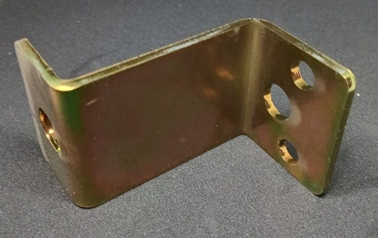 Zinc-plated metal L-bracket with mounting holes on a dark surface