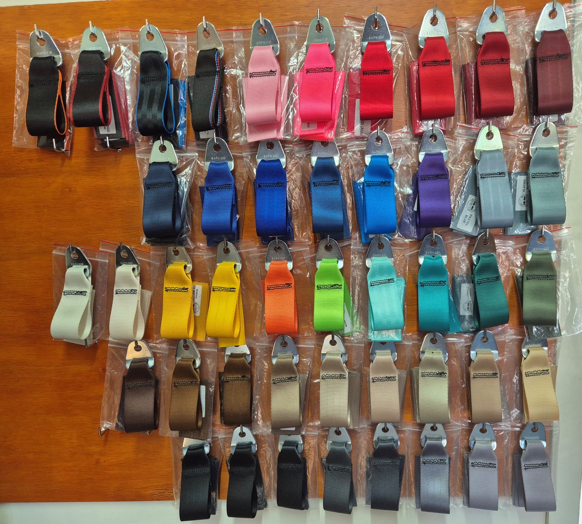 A wall with different colour seatbelts available.