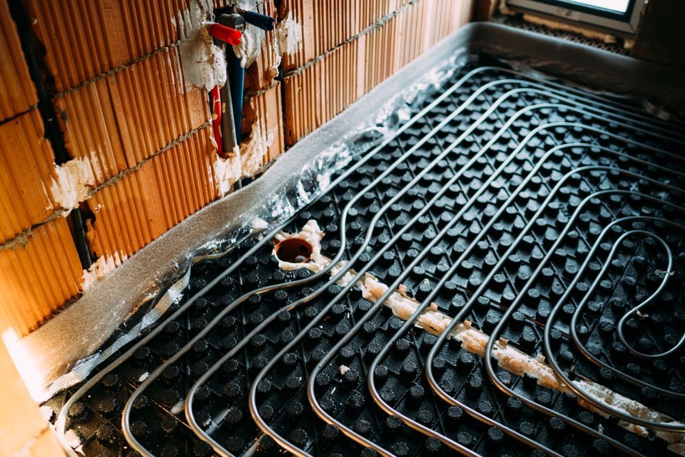 Pipes Laid on A Black Plastic Base for Underfloor Heating — Illawarra Underfloor Heating In Bellambi, NSW