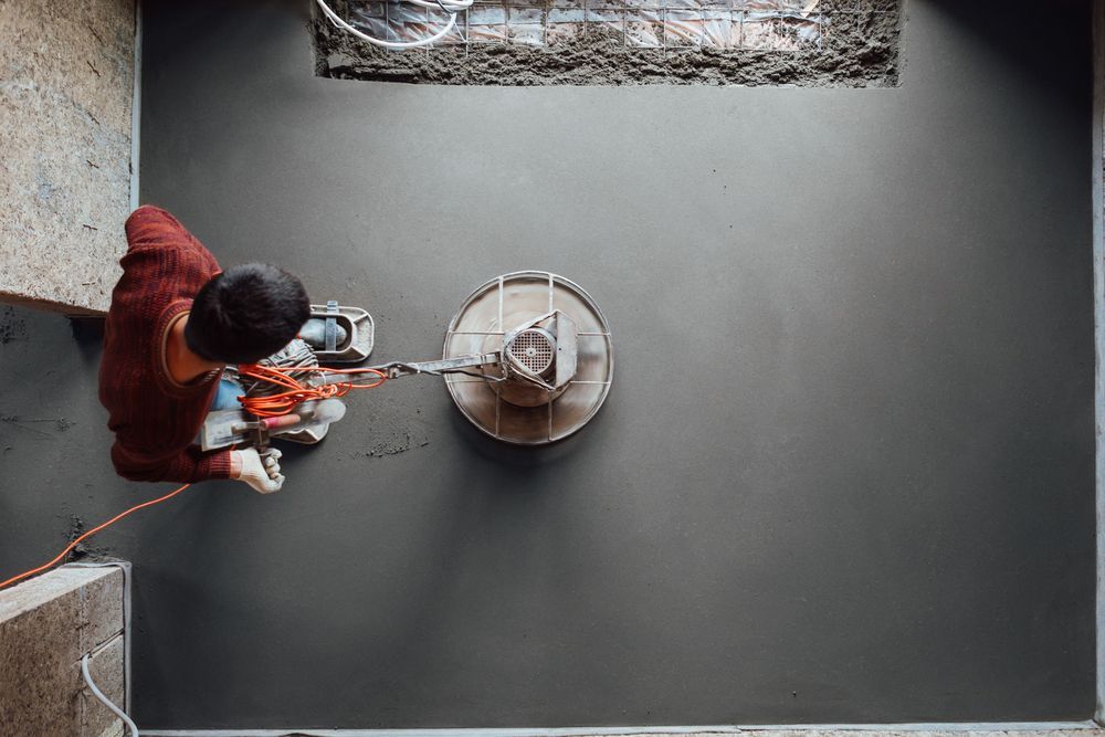 Person Using a Concrete Grinder — Illawarra Underfloor Heating In Kiama, NSW