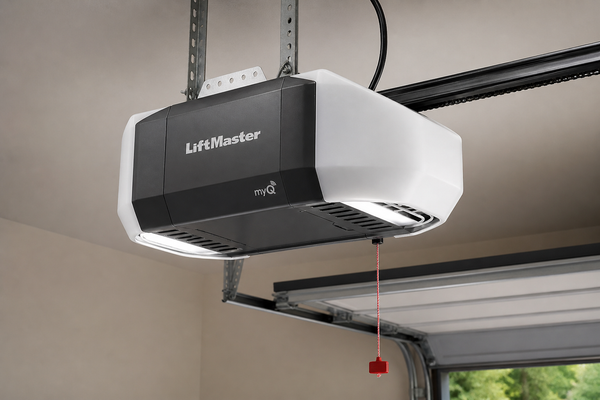 White and black LiftMaster garage door opener mounted to a ceiling track in a garage
