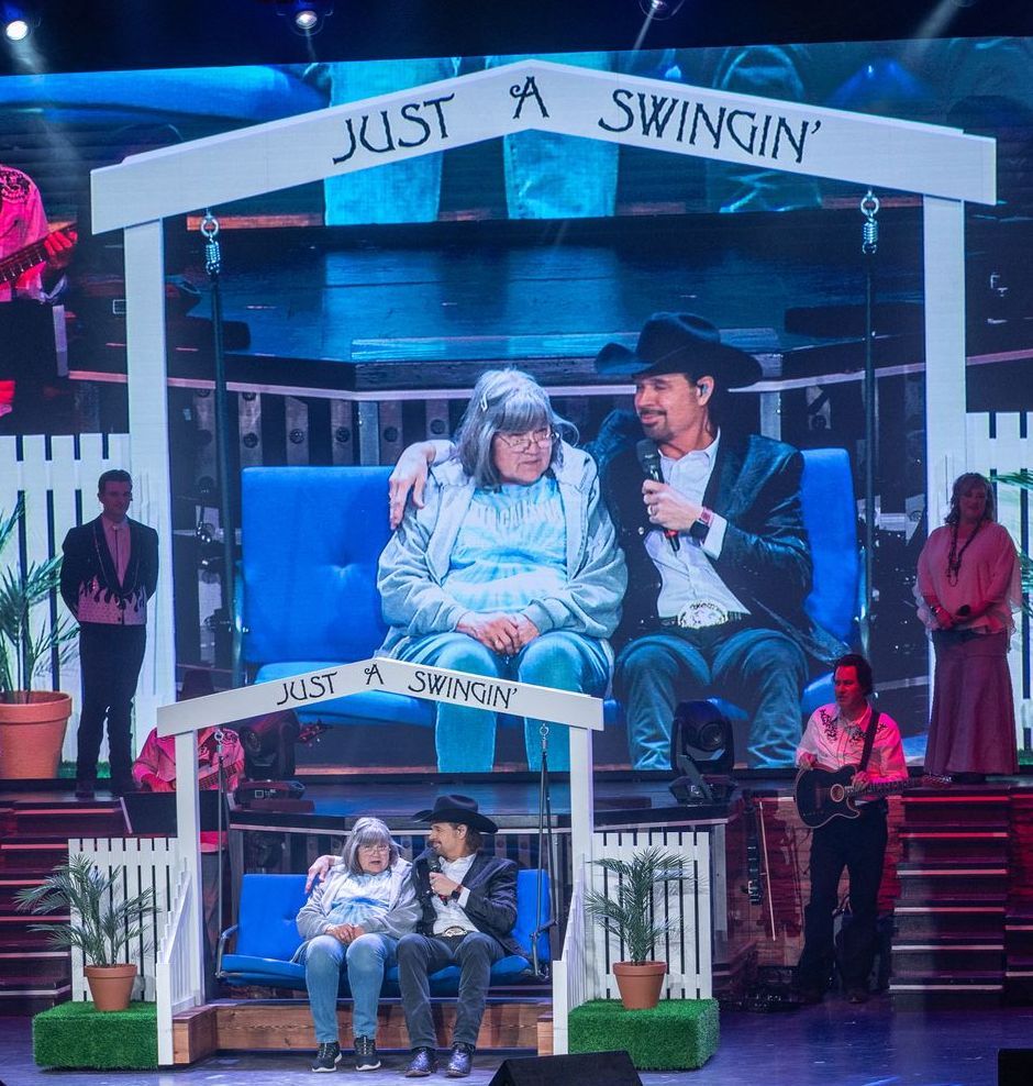 A stage set features a bench titled 