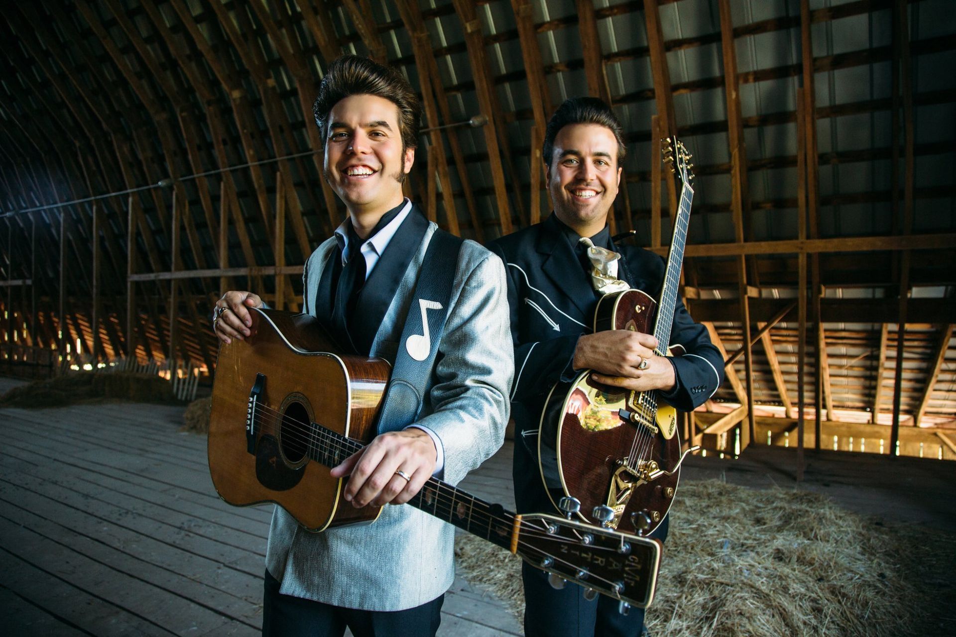 two men in a barn with guitars, black and white 