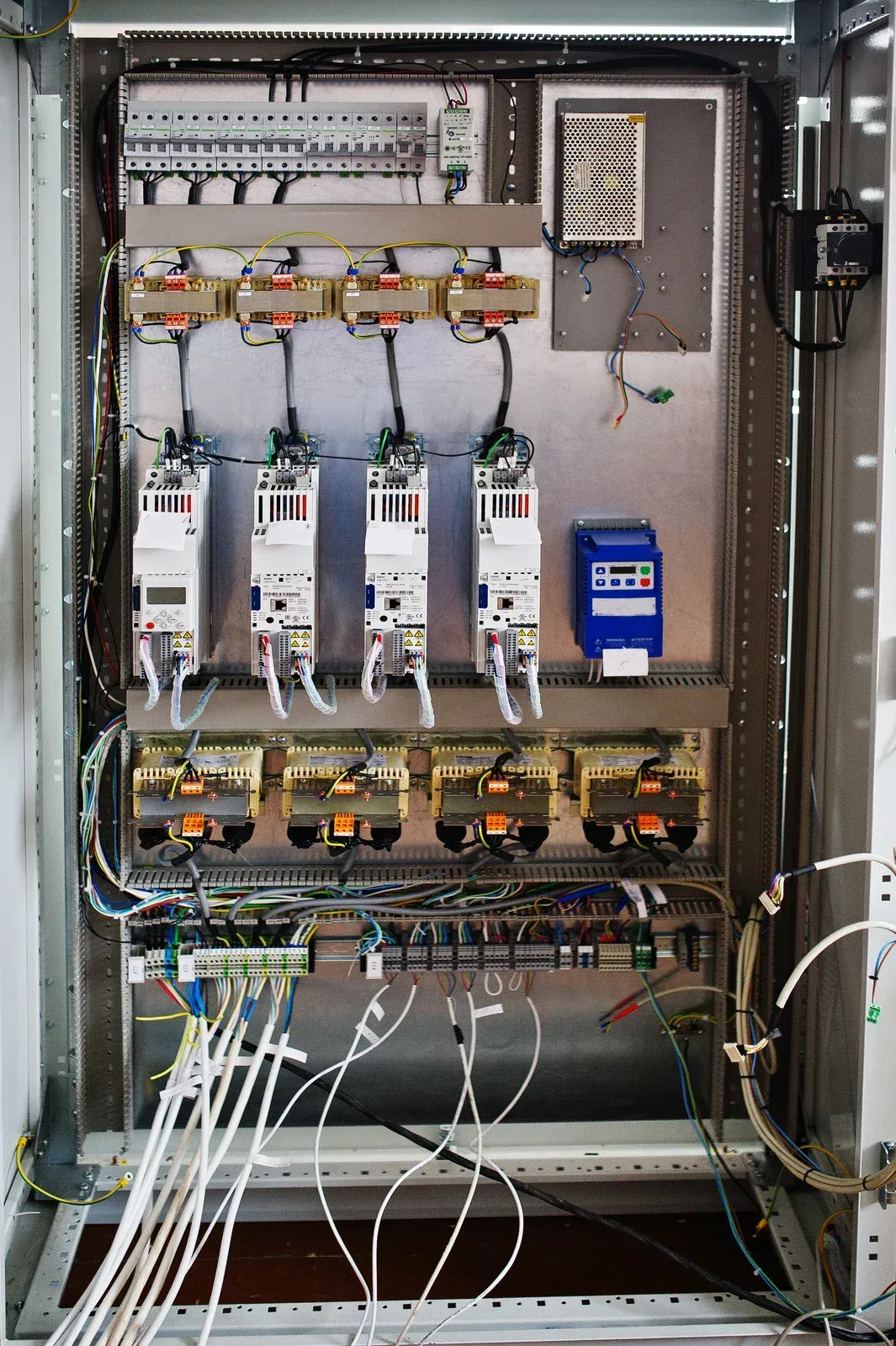 Electrical control panel with rows of components and wiring.