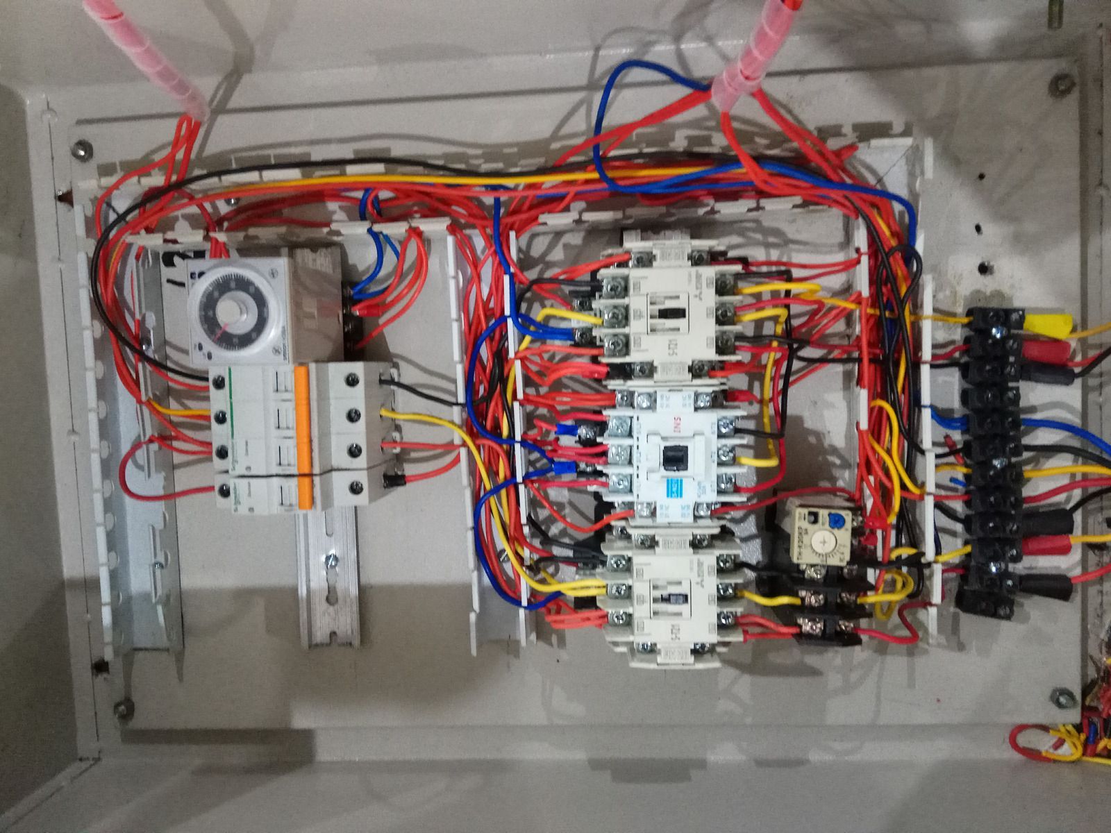 Electrical control panel with numerous colored wires and components.