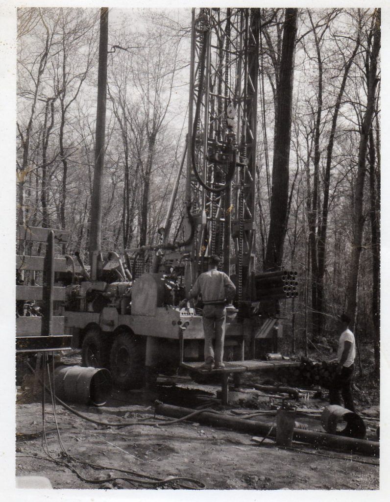 A black and white photo of a drill in the woods