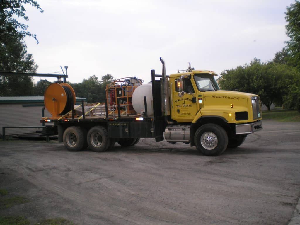 A yellow truck is parked in a parking lot