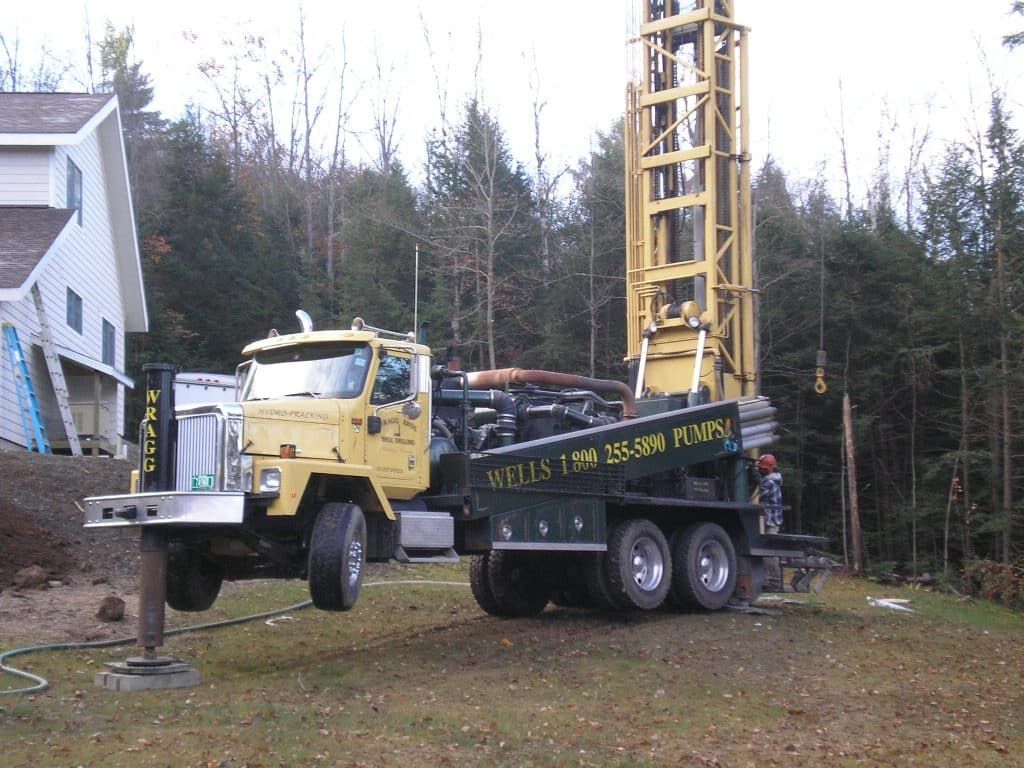 A yellow truck with the word wells on the side from Wragg Brothers Well Drilling