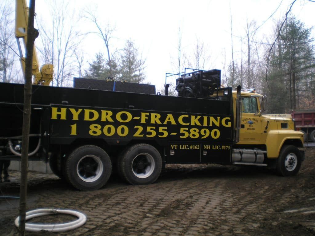A yellow truck that says hydro-fracking on the side from Wragg Brothers Well Drilling