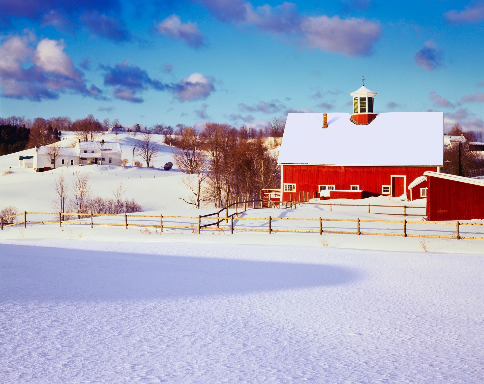 Snow-covered residential wellhead in rural New England during winter