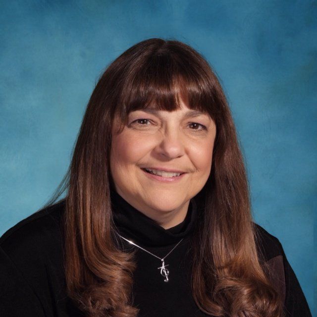 A woman wearing a necklace with the letter n on it